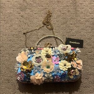 Bebe Blue and Gold Clutch with Floral Embellishments
